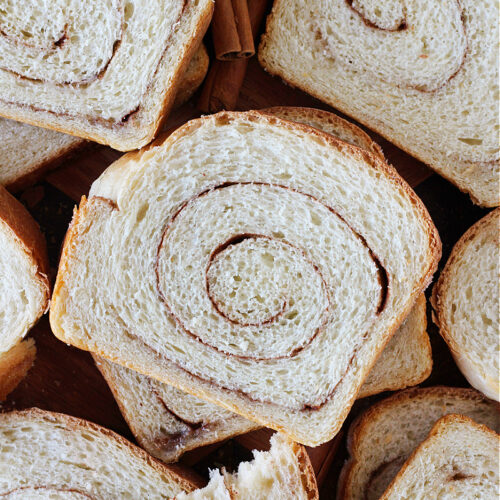 Cinnamon swirl sourdough bread slices sitting atop eachother.