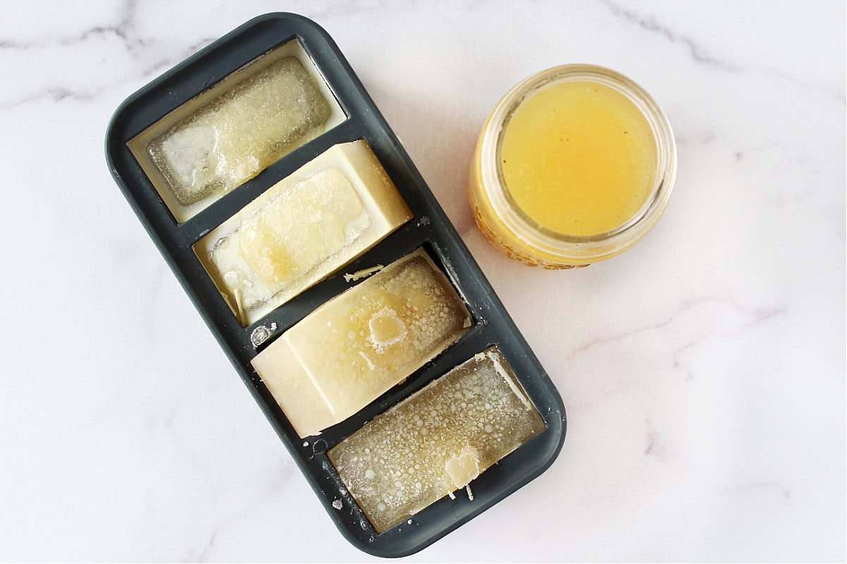 Frozen chicken broth in Souper Cubes and a jar of homemade broth.