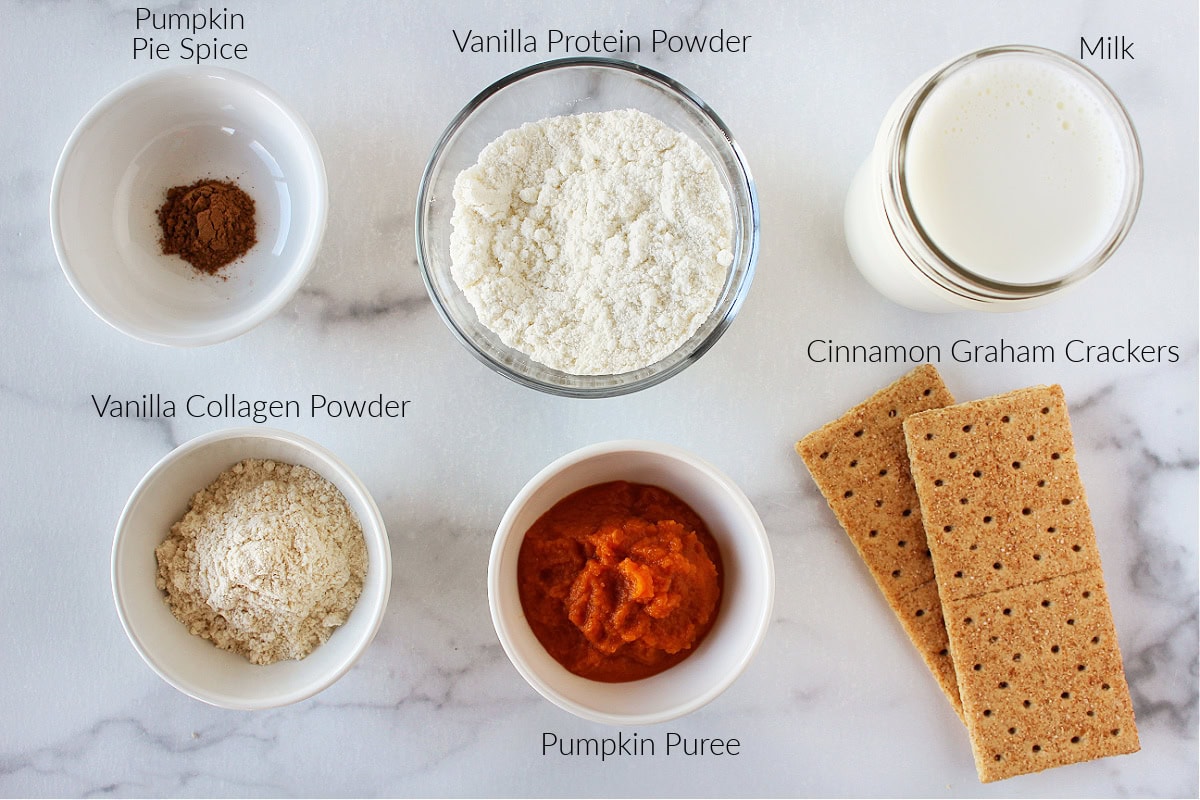 Labeled ingredients for pumpkin pie ice cream on a white marble countertop.