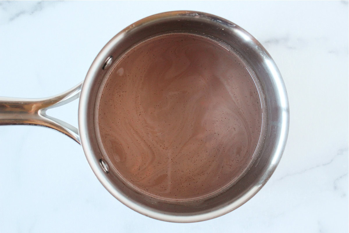 Hot chocolate in a small metal saucepot.