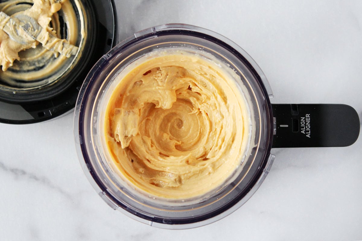 Swirls of pumpkin pie ice cream in a Ninja Creami bowl.