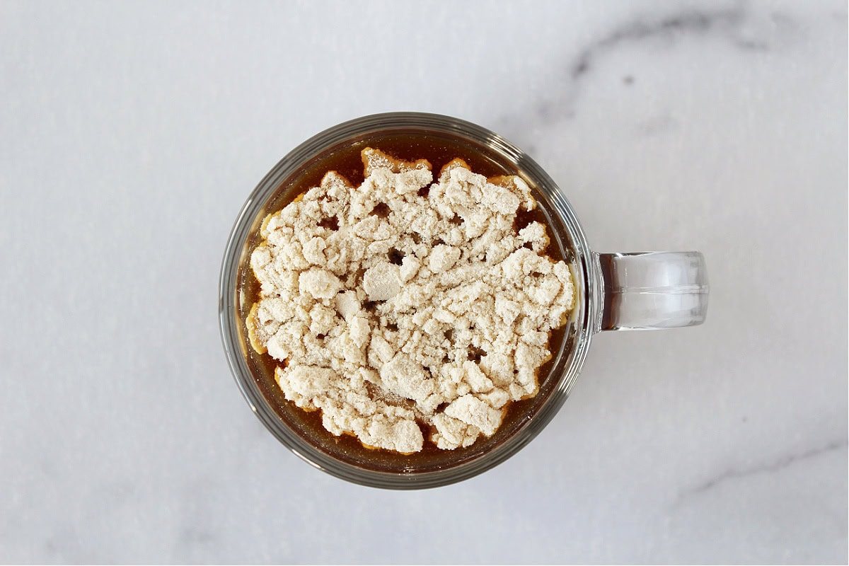 Hot coffee in a glass mug topped with vanilla collagen.