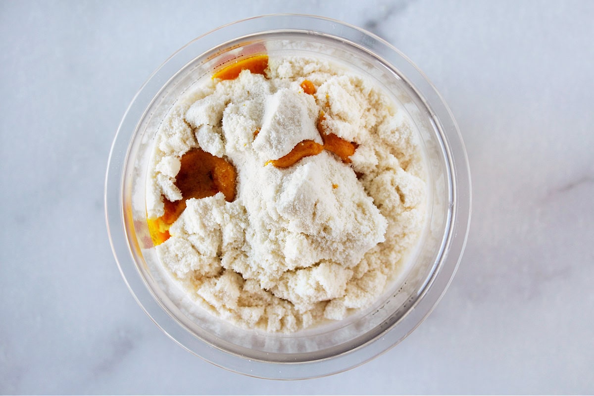 Cake batter extract on protein powder in Ninja Creami pint.