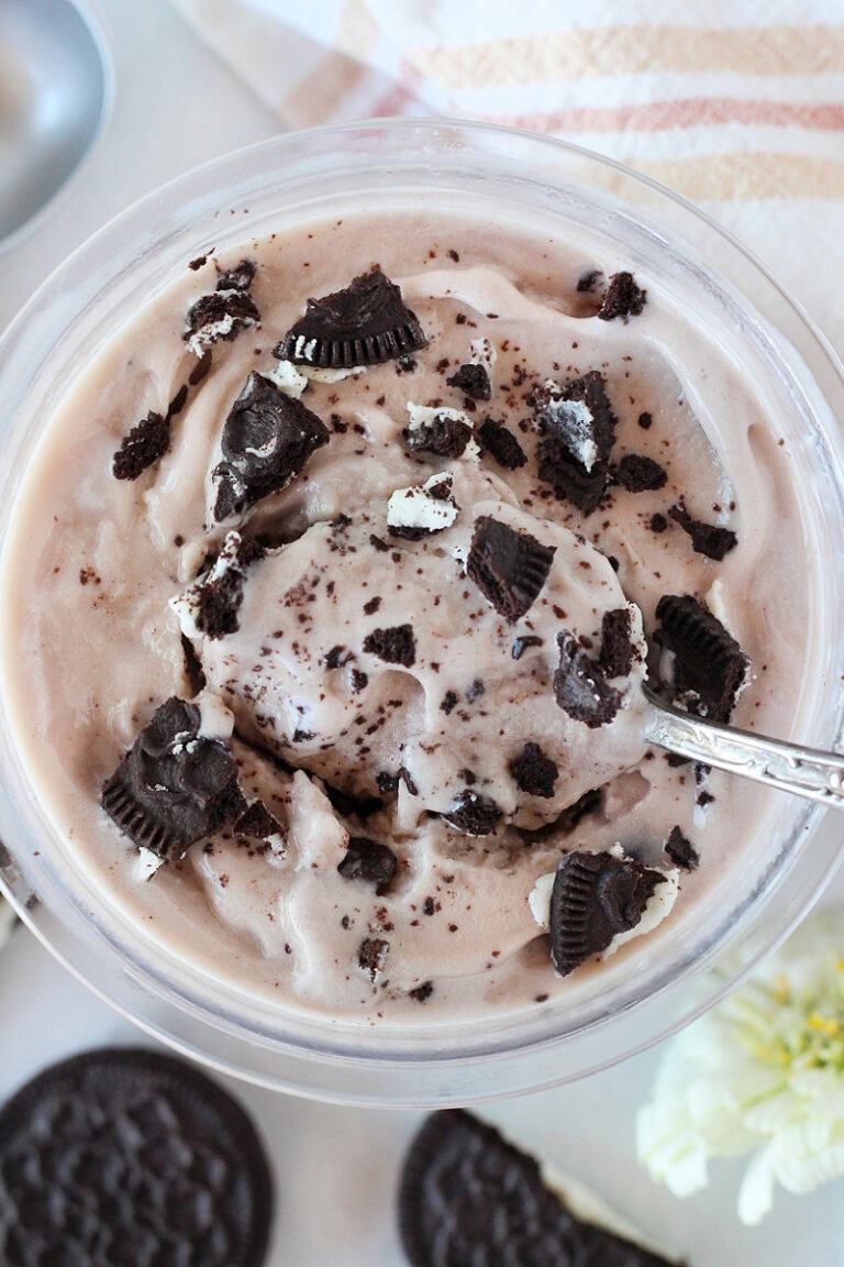 Vintage spoon in cookies and cream ice cream topped with crushed Oreos.