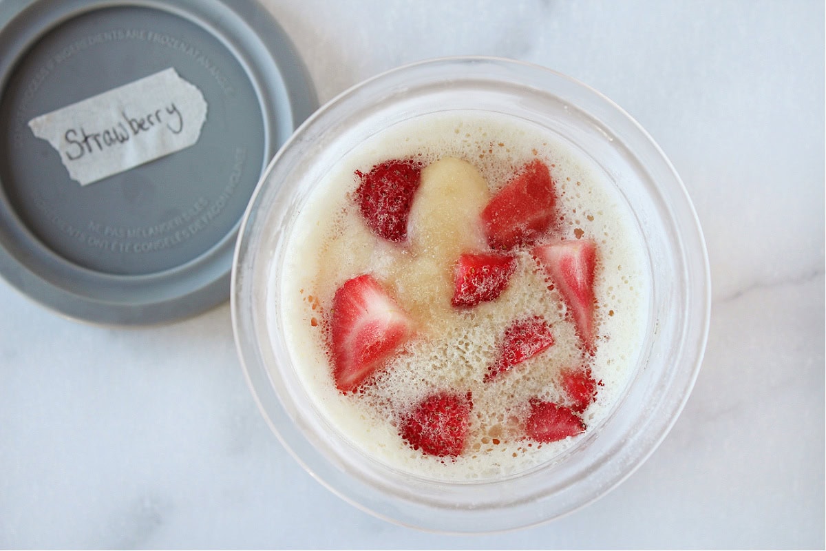 Frozen strawberries in unblended ice cream for a Ninja Creami.