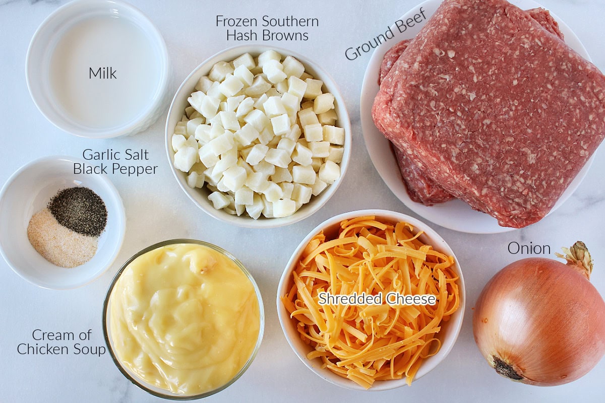 Labeled ingredients for ground beef and potato casserole on a white marble countertop.