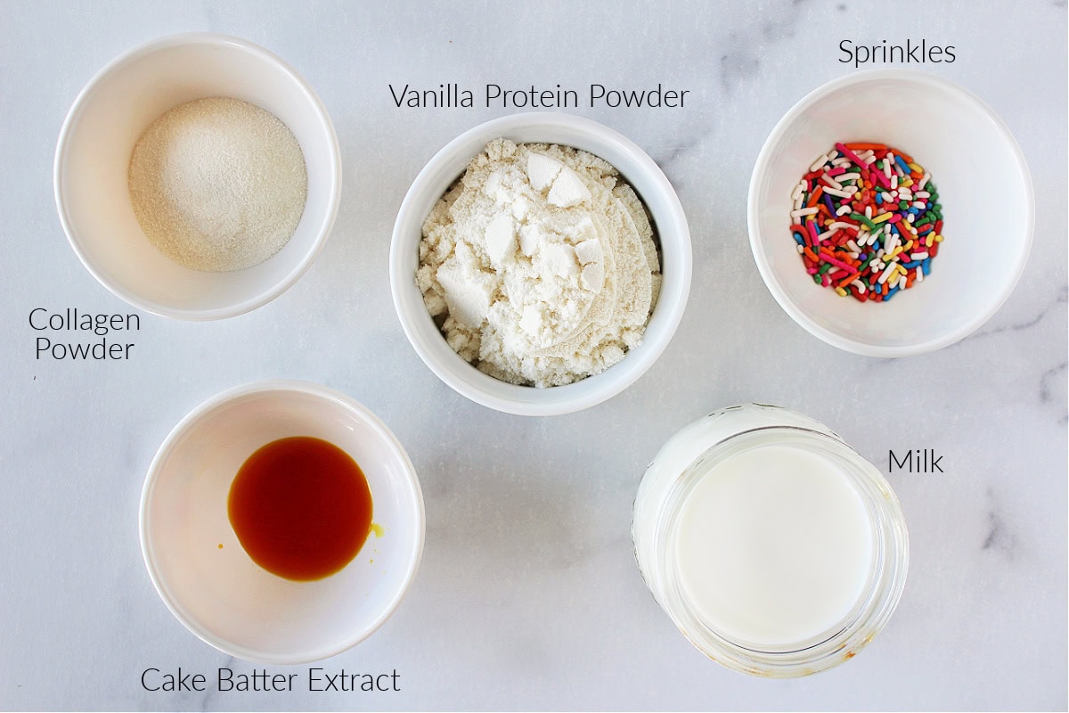Labeled ingredients for Ninja Creami cake batter ice cream on white marble countertop.