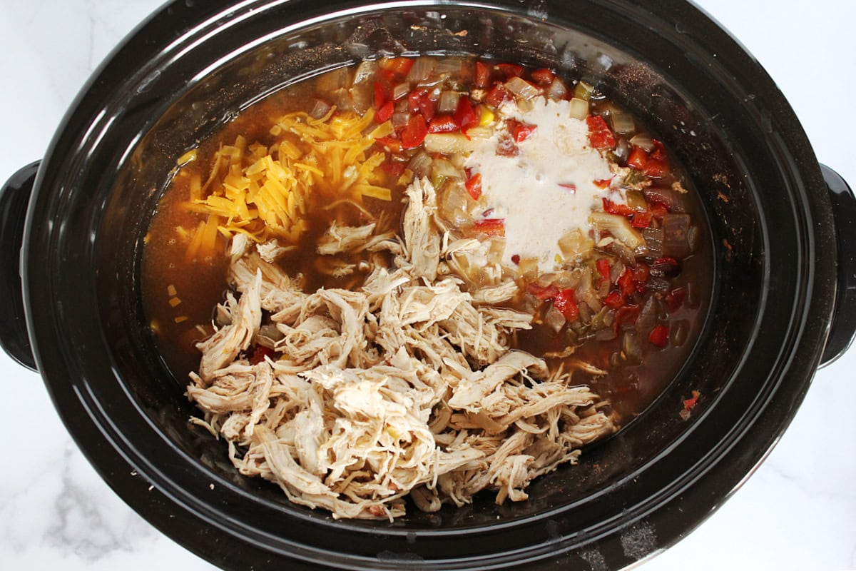 Shredded chicken and cheese, tempered yogurt, in a slow cooker with soup.