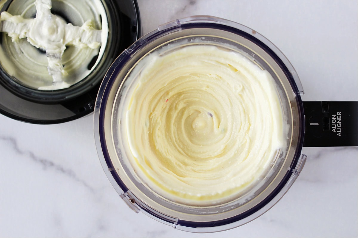 Rainbow sprinkles in cake batter ice cream in outer Ninja Creami bowl.