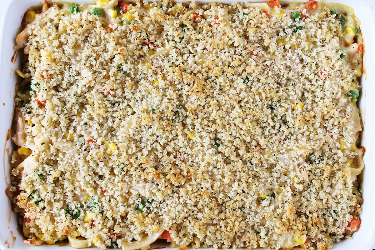 Baked chicken noodle casserole with golden brown breadcrumbs on top.