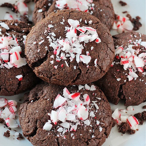 Crushed candy canes on top of brownie cookies on a plate.