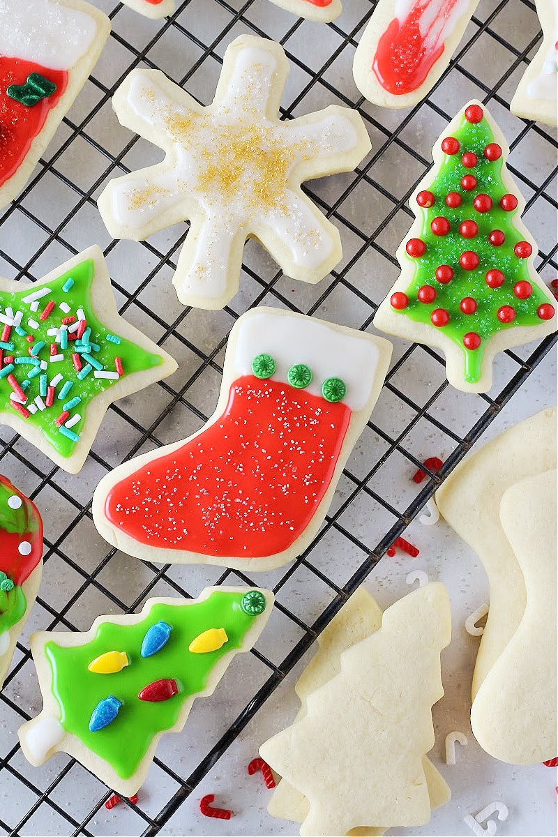 Decorated Christmas sugar cookies on a wire cooling rack.