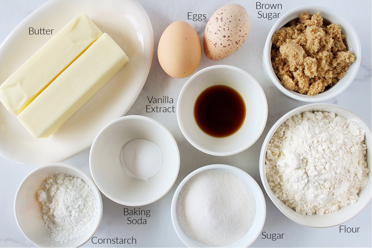 Labeled ingredients for brown butter cookies on a white marble countertop.