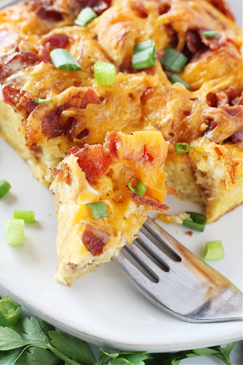 A piece of croissant egg bake on a fork.