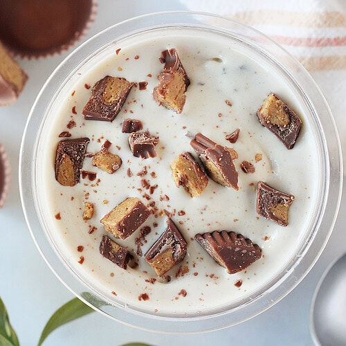 Chopped Reese's peanut butter cups on top of homemade protein ice cream.
