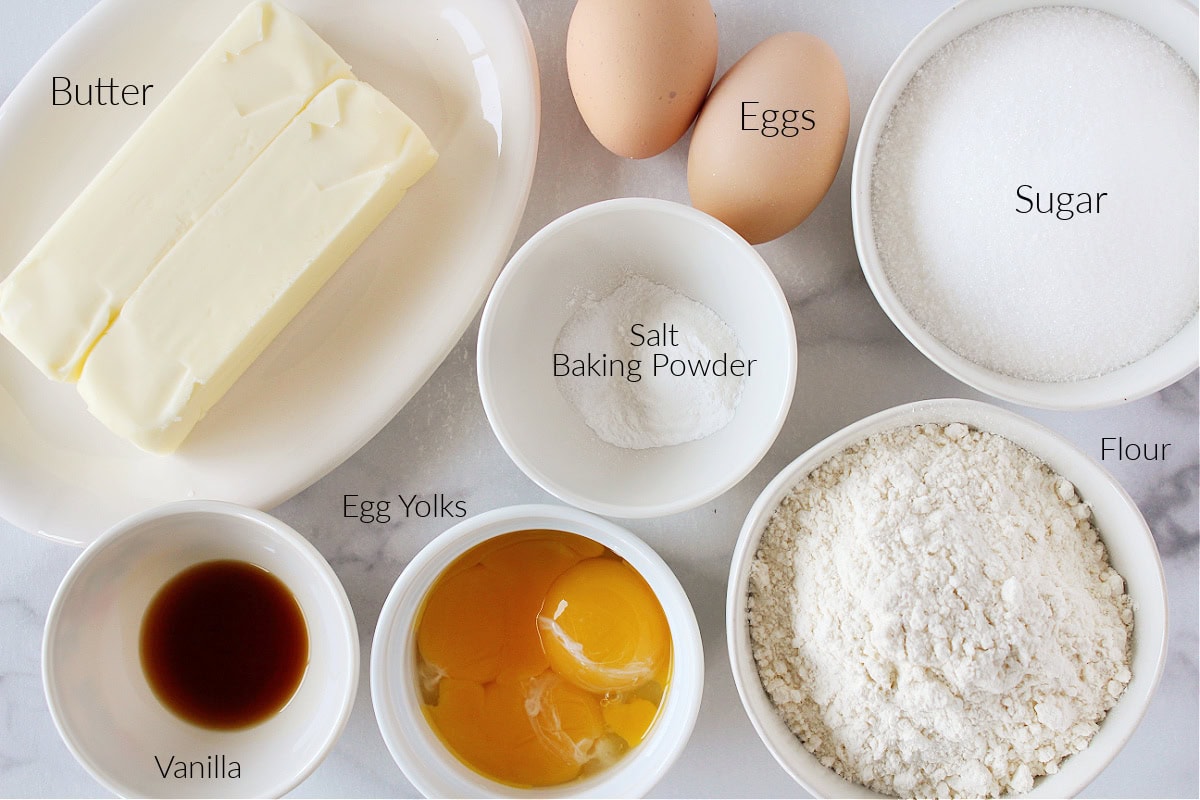 Labeled ingredients for Valentine Sugar Cookies on a white marble countertop.