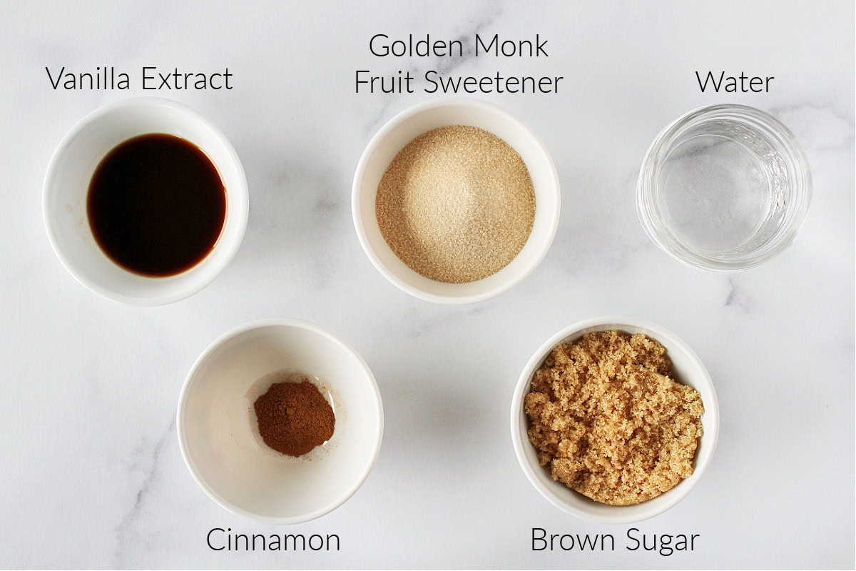 Labeled ingredients for cinnamon brown sugar coffee syrup on a white marble countertop.
