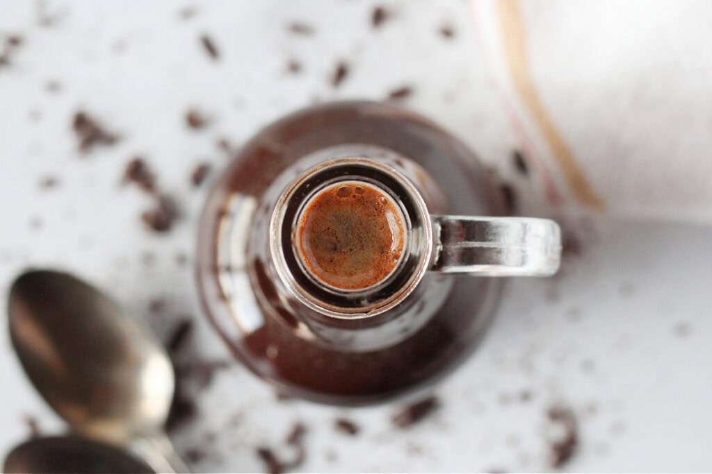 Looking at the top of homemade mocha coffee syrup in a glass bottle.