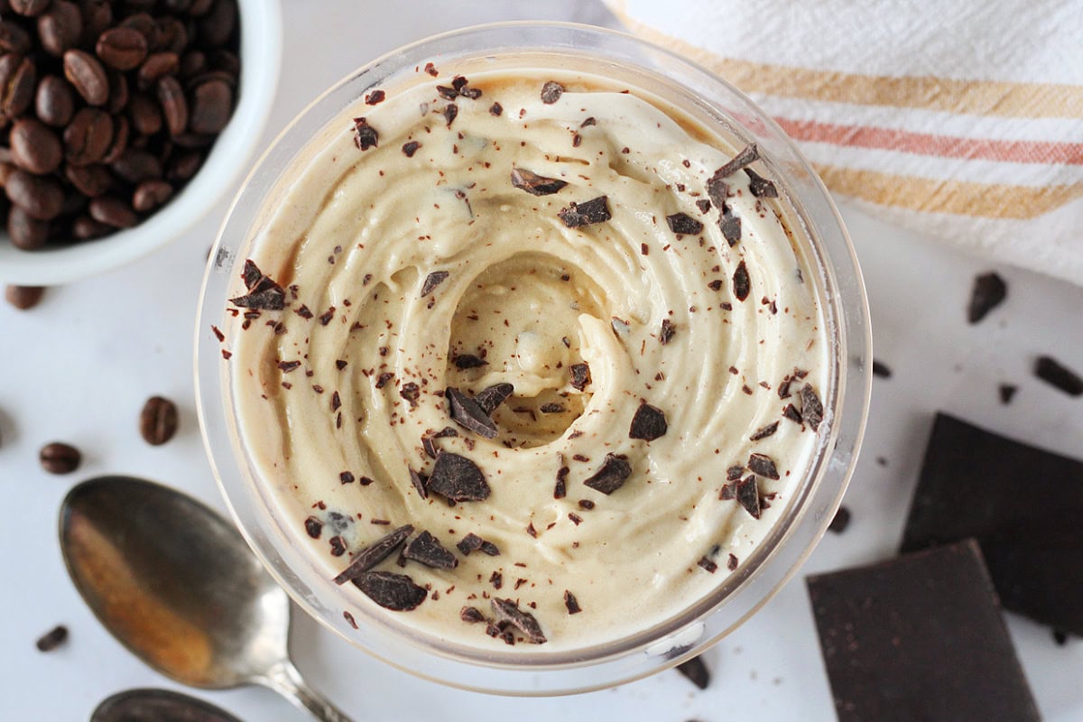 Chopped chocolate bar on top of swirled Ninja Creami espresso ice cream.