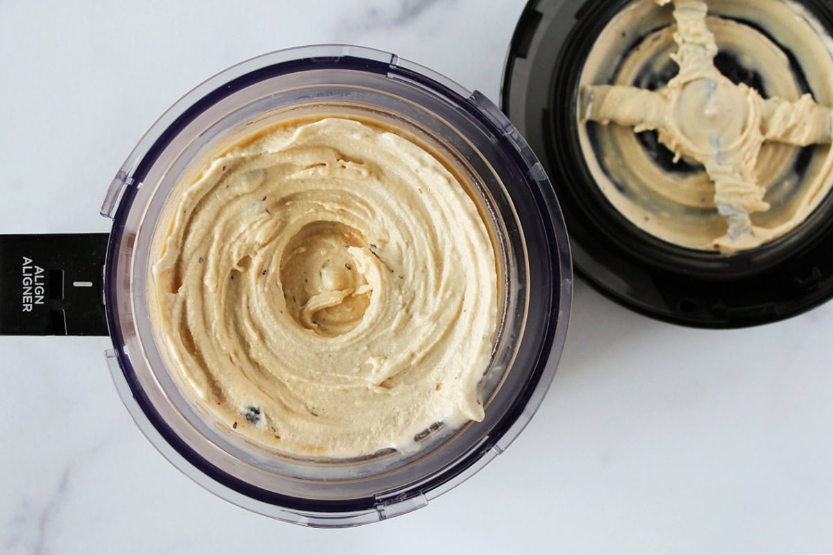 Espresso ice cream with chocolate chips in a Ninja Creami outerbowl and lid.