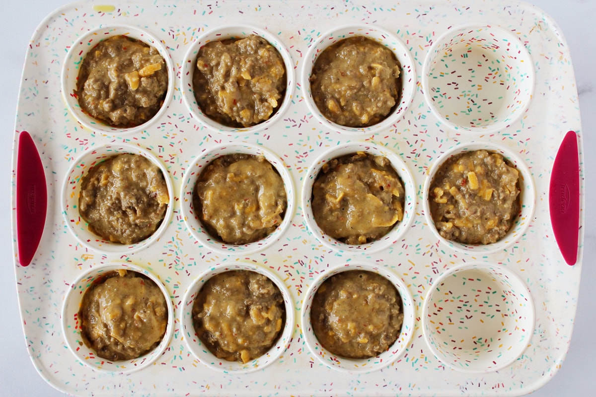 Cheesy sausage pancake mix batter in a silicone muffin pan.