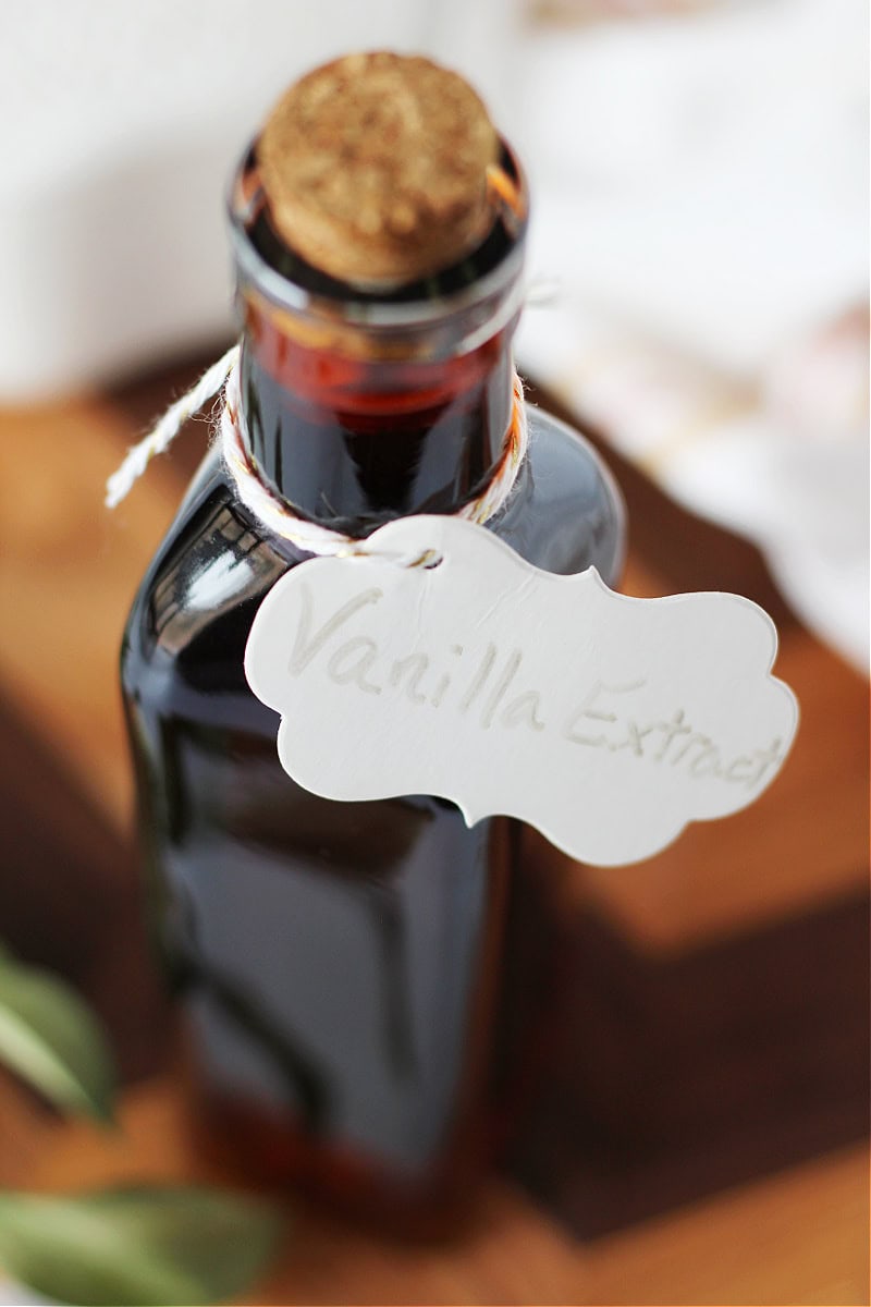 A tall bottle of homemade vanilla with a handwritten label.
