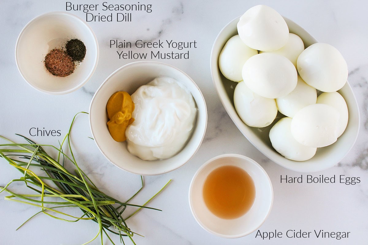 Labeled ingredient for healthy egg salad on a white marble countertop.