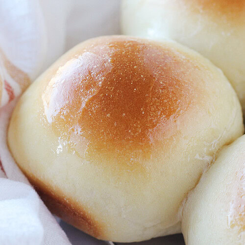 A shiny buttery top on homemade sourdough rolls.