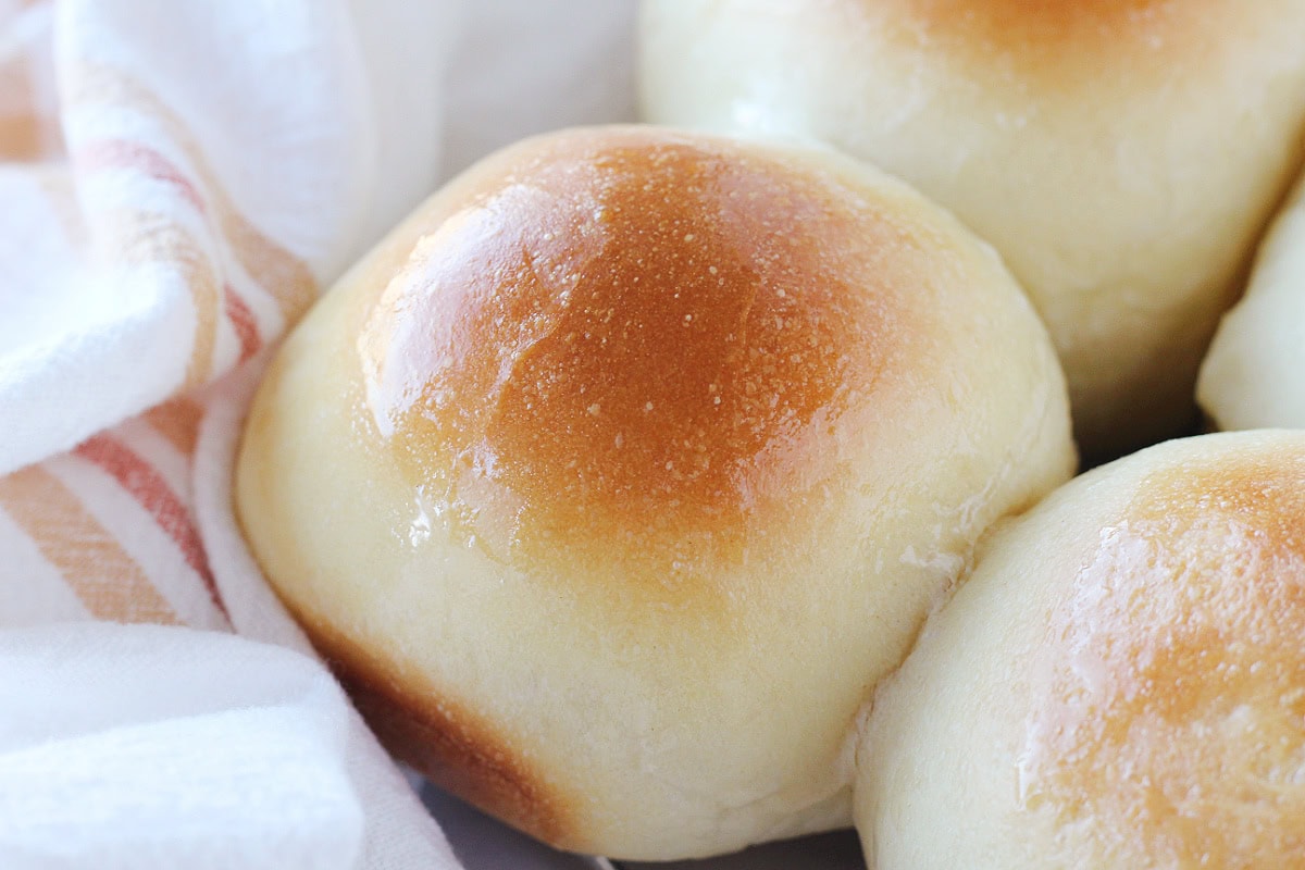 A shiny buttery top on homemade sourdough rolls.
