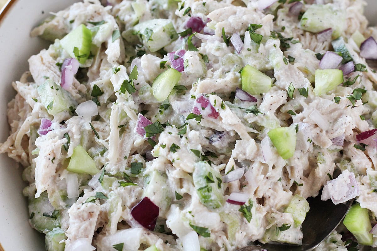 Tzatziki chicken salad with cucumber and red onion topped with parsley.