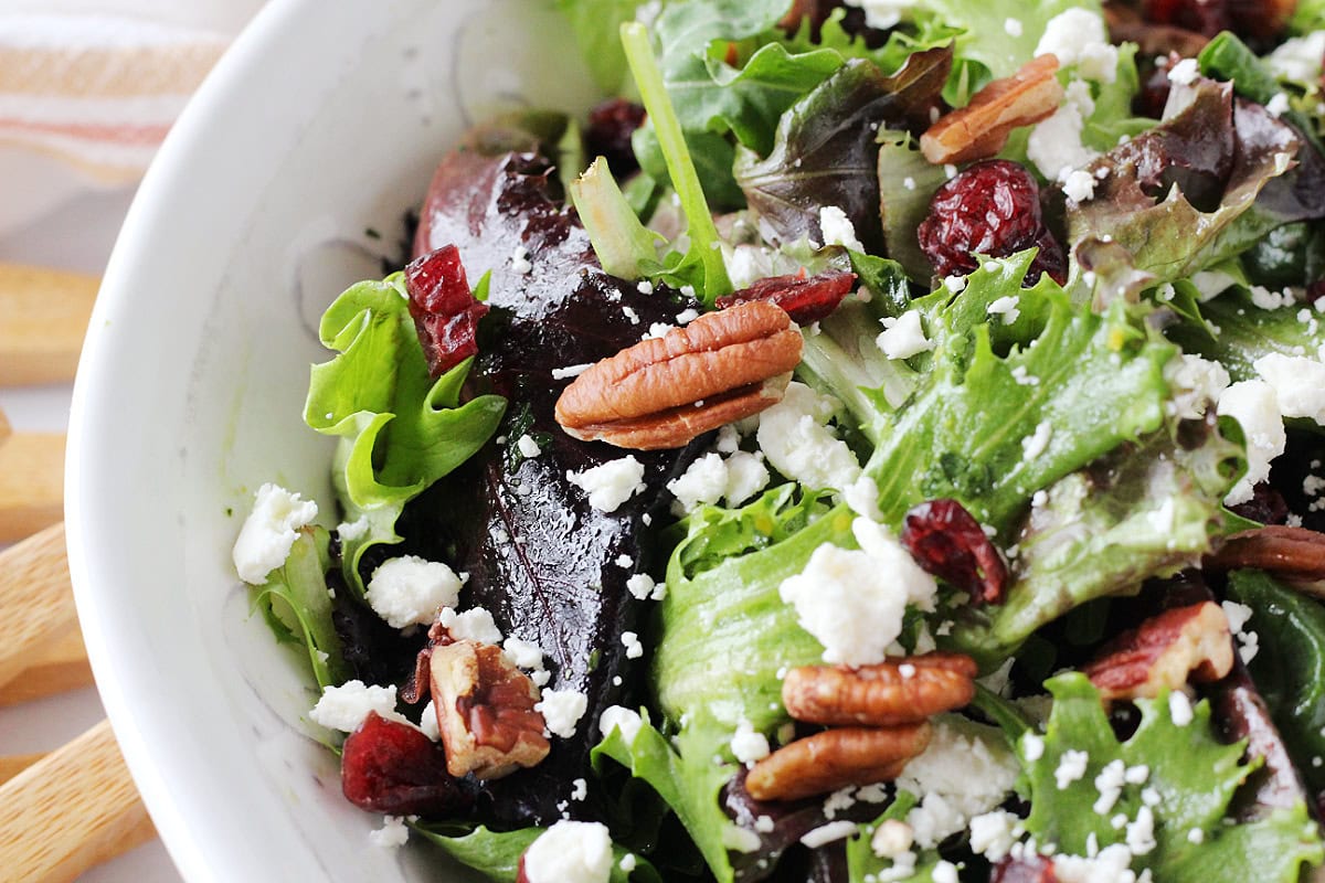 Halved pecans, crumbled feta cheese, and dried cranberries on mixed greens.
