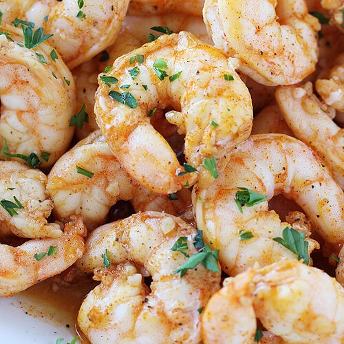 Juicy baked shrimp topped with chopped parsley.