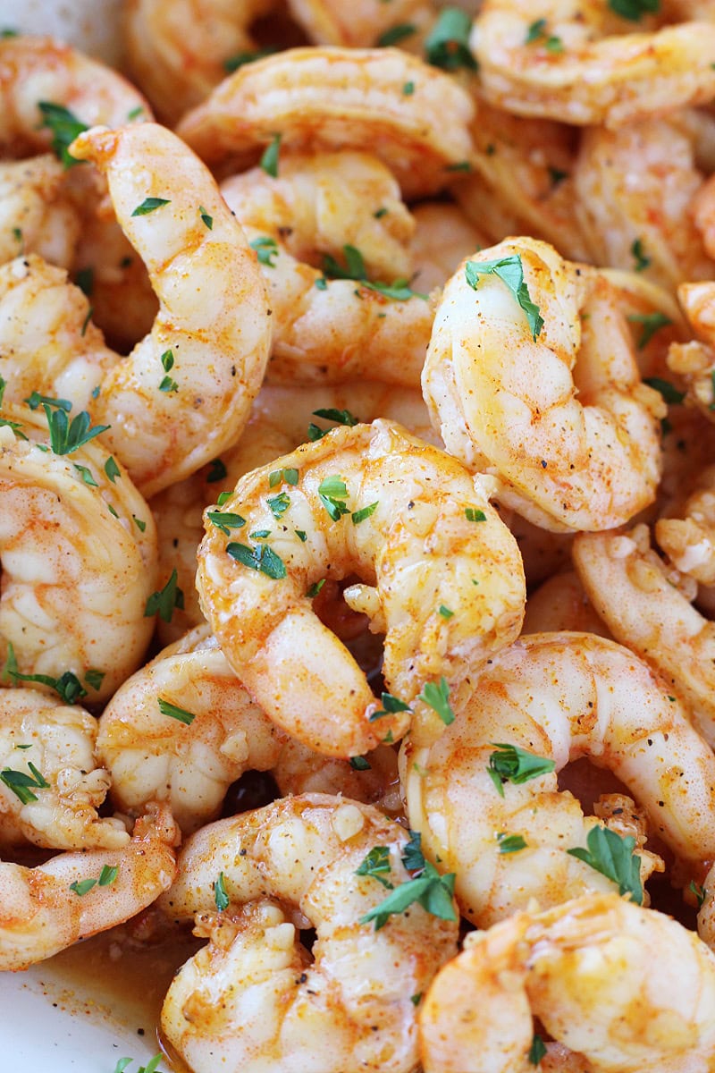 Juicy baked shrimp topped with chopped parsley.