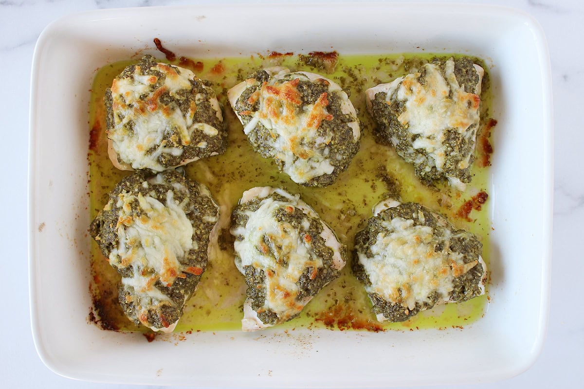 Melted mozzarella cheese on top of six walnut pesto baked chicken breasts.